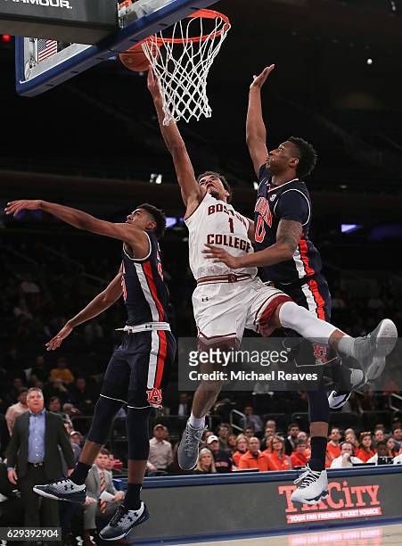 Jerome Robinson of the Boston College Eagles puts up a layup defended by Horace Spencer and TJ Lang of the Auburn Tigers in the first half of the...