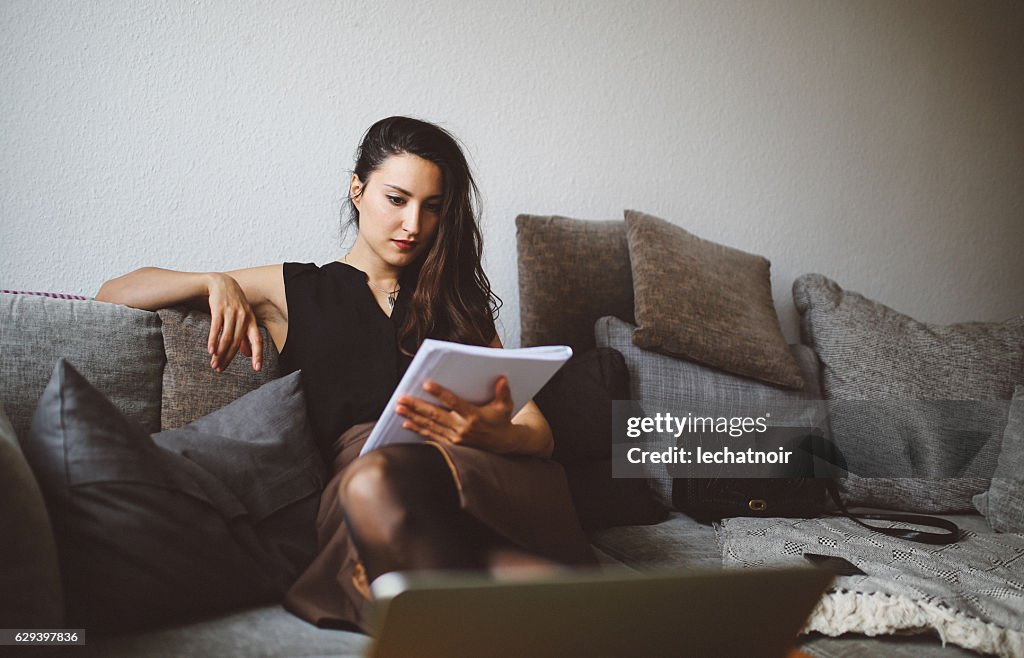 Young woman reading at home