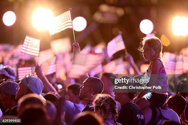 Young girl is seen in the crowd of service men and women during "Spike's Rock the Troops" event held at Joint Base Pearl Harbor - Hickam on October...