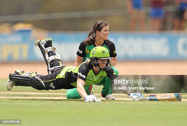 Alex Blackwell of the Thunder dives to make her crease as she runs between the wickets as she bats during the Women's Big Bash League match between...