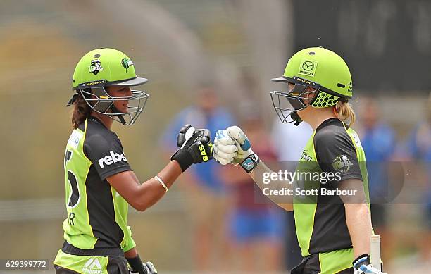 Alex Blackwell and Harmanpreet Kaur of the Thunder celebrate after Kaur hit a six during the Women's Big Bash League match between the Melbourne...