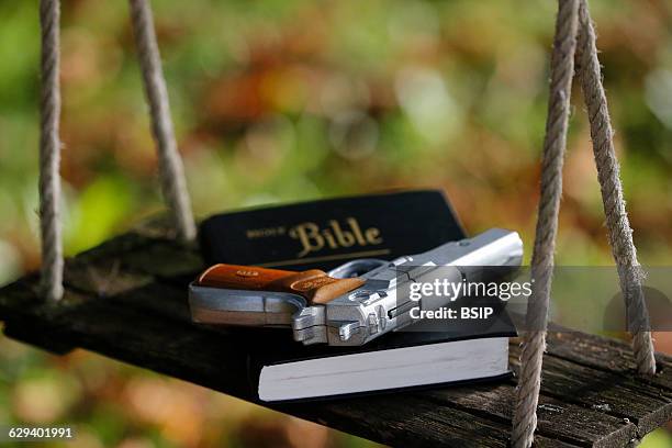 Holy Bible and gun.