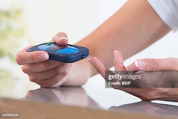Woman checking her blood glucose level.