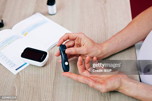 Pregnant woman checking her blood glucose level.