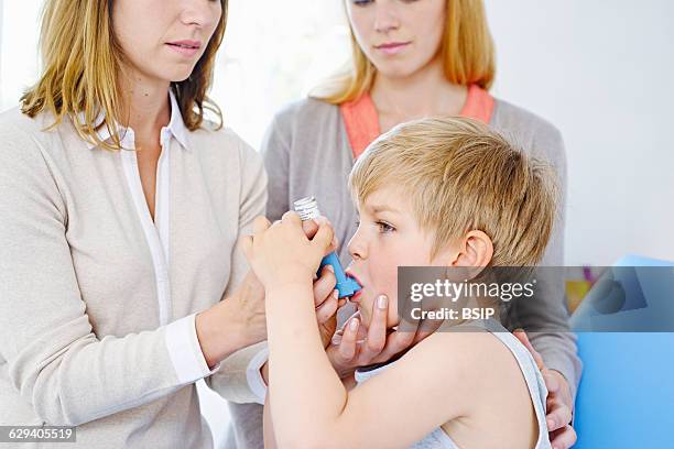 Doctor informing a mother about the use of a bronchodilator.