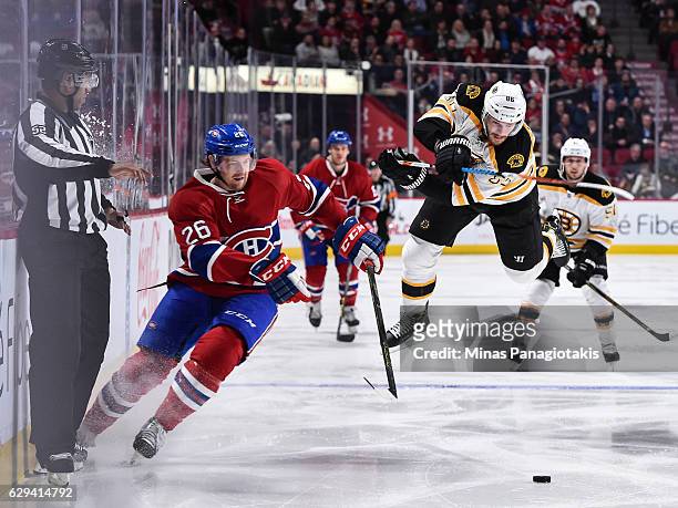 Kevan Miller of the Boston Bruins jumps as Jeff Petry of the Montreal Canadiens skates the puck during the NHL game at the Bell Centre on December...
