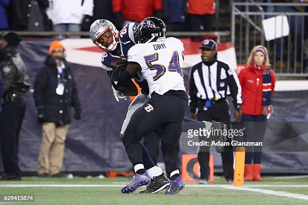 Martellus Bennett of the New England Patriots makes a touchdown reception against Zachary Orr of the Baltimore Ravens during the third quarter of...