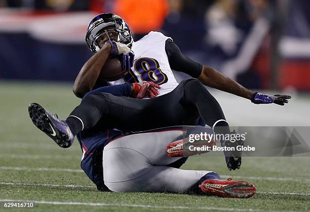 New England Patriots' Duron Harmon tackles Baltimore Ravens' Breshad Perriman during the second quarter. Harmon was injured on the play. New England...