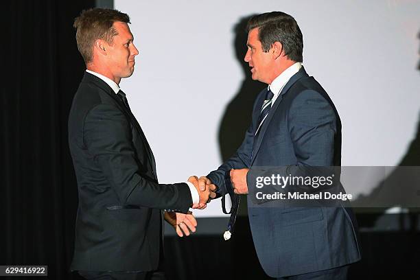 Sam Mitchell of the West Coast Eagles receives his Browlnow from former Hawks teammate Shane Crawford during the 2012 Brownlow Medal presentation on...
