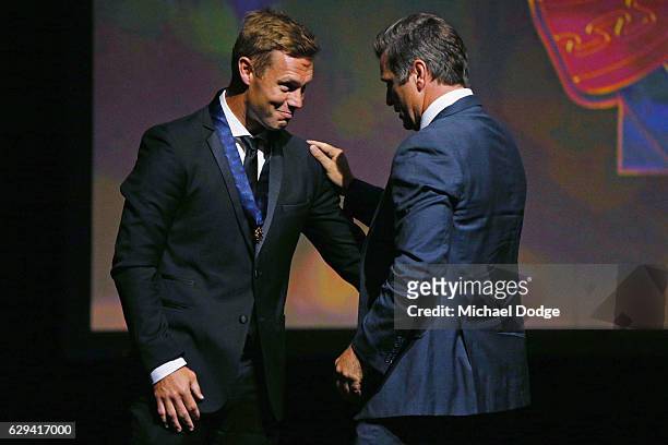 Sam Mitchell of the West Coast Eagles receives his Brownlow from former Hawks teammate Shane Crawford during the 2012 Brownlow Medal presentation on...