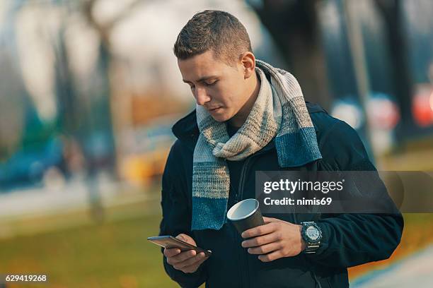 young man with smart phone and coffee - digital composite stock pictures, royalty-free photos & images