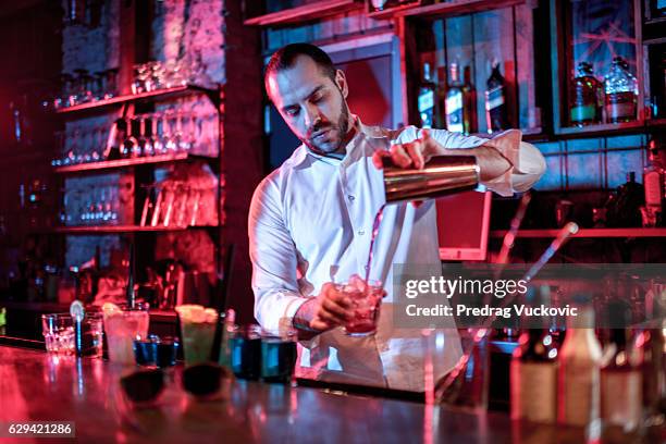 bartender mixing a cocktail - barman stock pictures, royalty-free photos & images