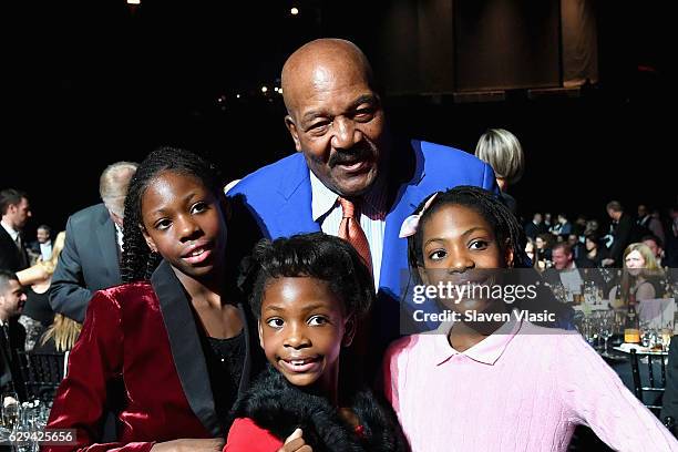 Football Player Jim Brown poses with Sportskids of the Year Track & Field Junior Olympians Brooke Sheppard, Rainn Sheppard, and Tai Sheppard during...