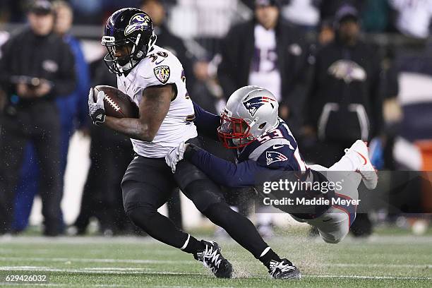 Kyle Van Noy of the New England Patriots attempts to tackle Kenneth Dixon of the Baltimore Ravens during the second half at Gillette Stadium on...