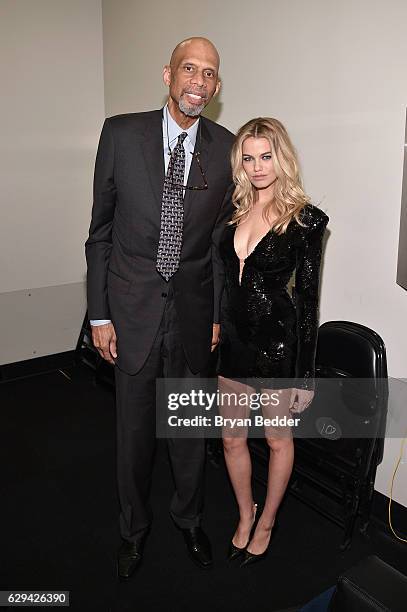 Basketball player Kareem Abdul-Jabbar and 2016 Sports Illustrated Swimsuit Cover Model Hailey Clauson pose backstage during the Sports Illustrated...