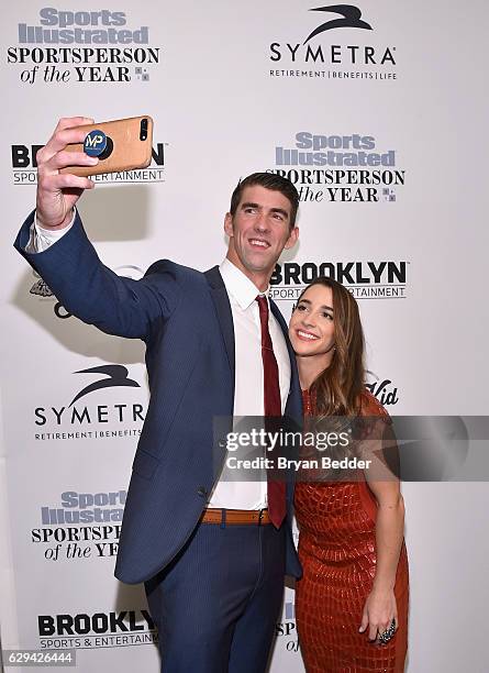 Olympic Swimmer Michael Phelps and Olympic Gymnast Aly Raisman take a selfie during the Sports Illustrated Sportsperson of the Year Ceremony 2016 at...