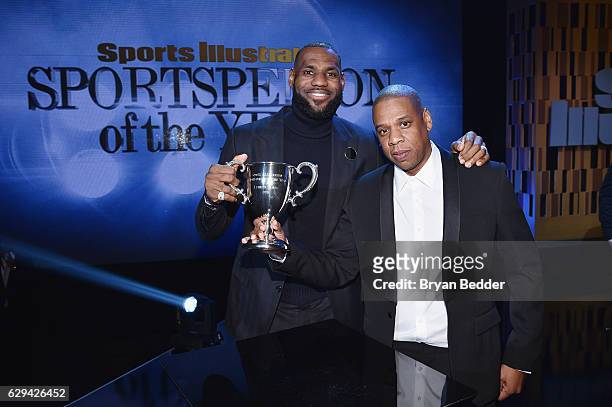 LeBron James and Jay Z pose onstage with an award during the Sports Illustrated Sportsperson of the Year Ceremony 2016 at Barclays Center of Brooklyn...