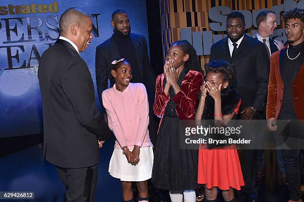 Jay Z meets SportsKids of the Year Track & Field Junior Olympians Brooke, Rainn, and Tai Sheppard onstage during the Sports Illustrated Sportsperson...