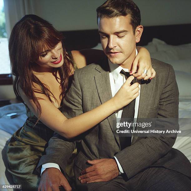 Woman Removing Mans Tie.