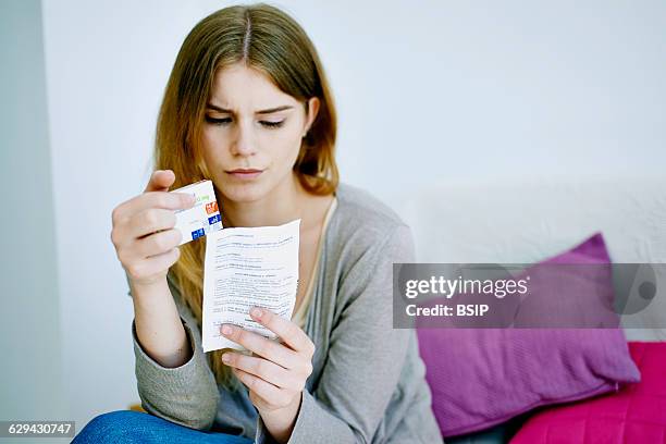 Woman reading paroxetine instruction sheet.