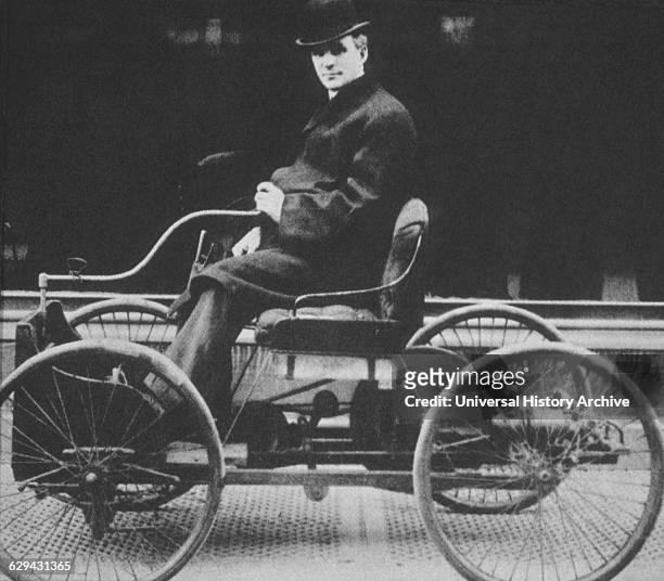 American inventor and industrialist, Henry Ford posing in the driving seat of his first car, the Quadricycle, New York City, 1910. Ford has brought...