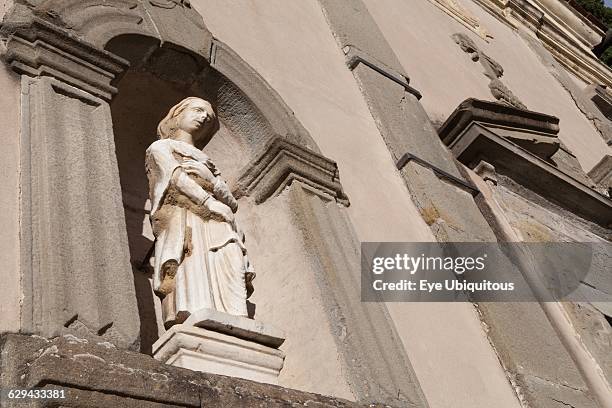 Italy. Tuscany. Lucca. Barga. Statue on the facade of Chiesa del St Crocifisso.