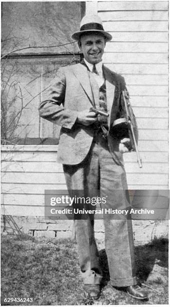 John Dillinger , American Gangster, Portrait holding Toy Gun Used to Escape Jail in Crown Point, Indiana, USA, 1934.