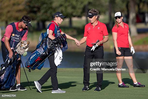 Bernhard and Christina Langer of Germany with caddies Chase De Jong and Jason Langer on the 18th fairway during the first round of the PNC Father/Son...