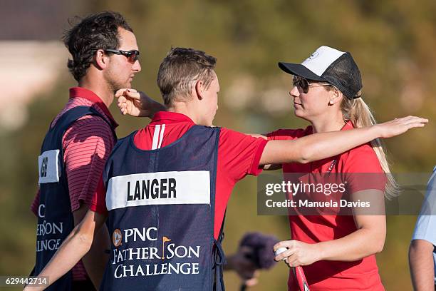 Jason and Christina Langer of Germany hug on the 18th green after the first round of the PNC Father/Son Challenge at The Ritz-Carlton Golf Club on...