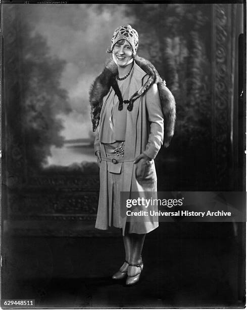 Fashionable Woman in Short Dress and Coat with Mink Fur Stole and Knit Cap, Portrait, circa 1923.