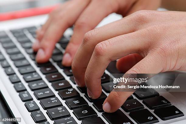 close up of a young woman's hands typing on her laptop - keyboard instrument stock pictures, royalty-free photos & images