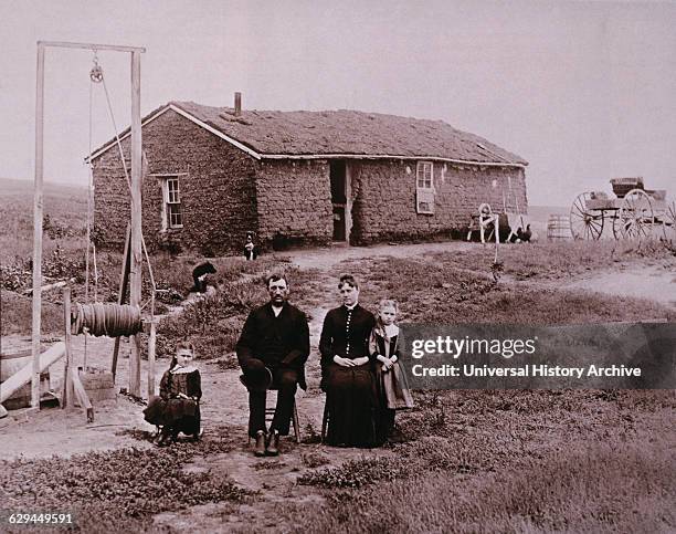 Pioneer Family in Front of Sod House, Portrait, Kansas, USA, circa 1880.