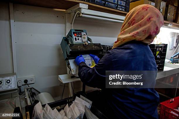 An employee seals prescription packets of medical cannabis during packaging at a plant operated by Breath of Life , in Kfar Pines, Israel, on...