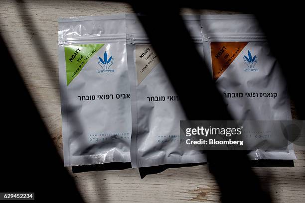 Sample packets of medical cannabis in three different flavours including crocus, right, sum sum, center, and sunflower, left, sit on display at the...