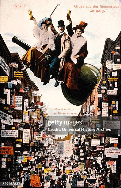 Three People Raising Glasses to Toast while Sitting on Cannon above Busy Street Scene, Liepzig, Germany, Postcard, circa 1907.