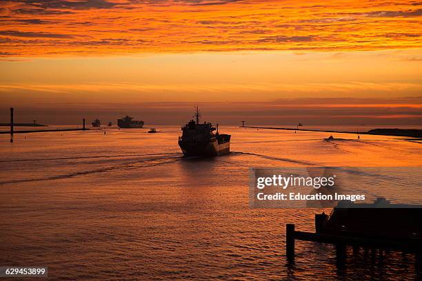 Sunset orange glow landscape clouds water, North Sea shipping, Port of Rotterdam, Hook of Holland, Netherlands.