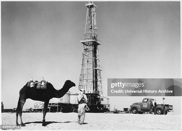 Man and Camel near Oil Well, Saudi Arabia, circa 1940's.