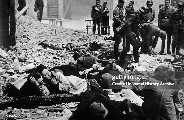 German Soldiers Inspecting the Dead in Warsaw Ghetto, Poland, 1943 .