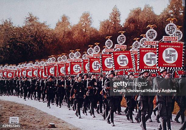 German SS Troops Bearing Standards March in Zeppelin Field, Nurnberg, Germany, 1933.