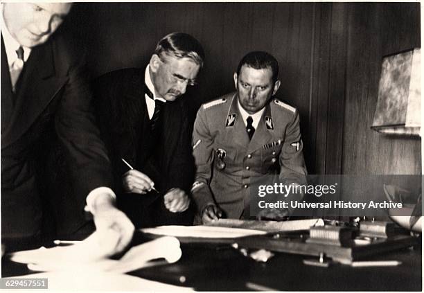 British Prime Minister Neville Chamberlain Signing Munich Agreement, Munich, Germany, September 30, 1938 .