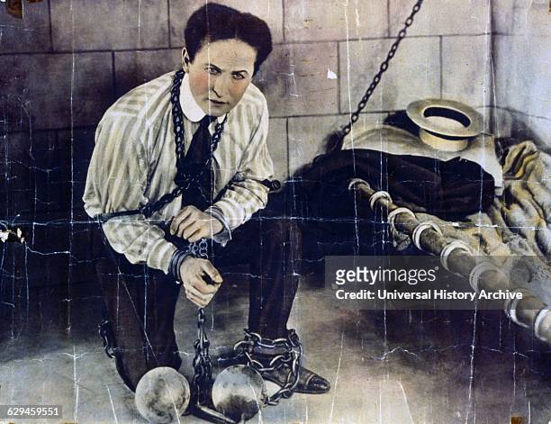Photographic print, hand coloured, poster format, of Harry Houdini a Hungarian-American illusionist and stunt performer, noted for his sensational...
