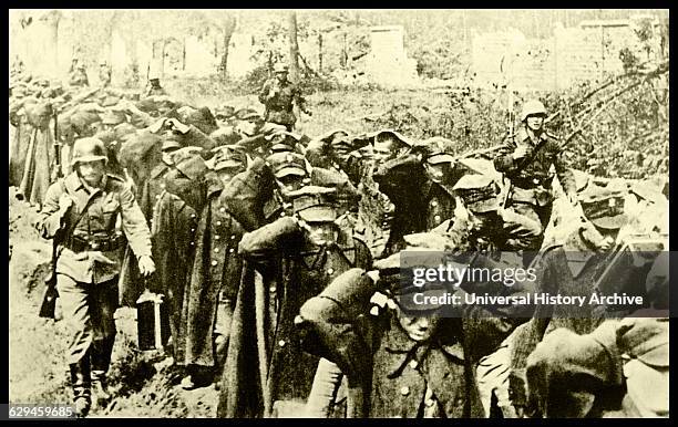 The battle for Westerplatte. Armed German soldiers are shown marching the remaining Polish soldiers , after the surrendering of Westerplatte in 1939.