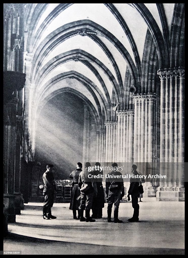 German soliders standing in a gothic cathedral. Dated 1940