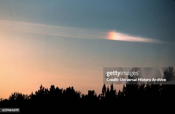 Photograph of a Parhelion, an atmospheric phenomenon that consists of a pair of bright spots on either side on the Sun, often co-occurring with a...