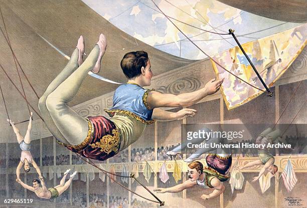 Five male trapeze artists performing at a circus c1890.