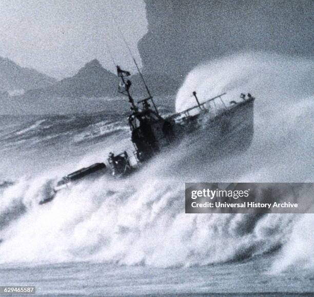 Photograph of a Coast Guard surf boat ploughing through the bar at Columbia River Entrance. Dated 1970.