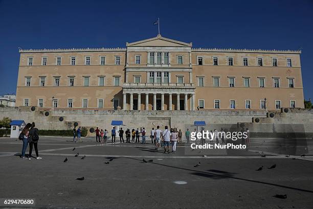 The Greek parliament or the Parliament of the Hellenic Republic during a crystal clear day with blue sky in Athens. In front of the parliament is the...