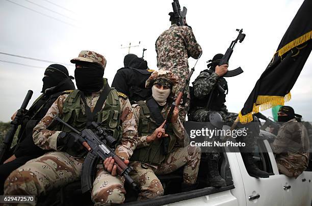 Palestinian militants from al-Quds Brigades the armed wing of the Islamic Jihad organization attend the funeral of seven Hamas gunmen who were killed...
