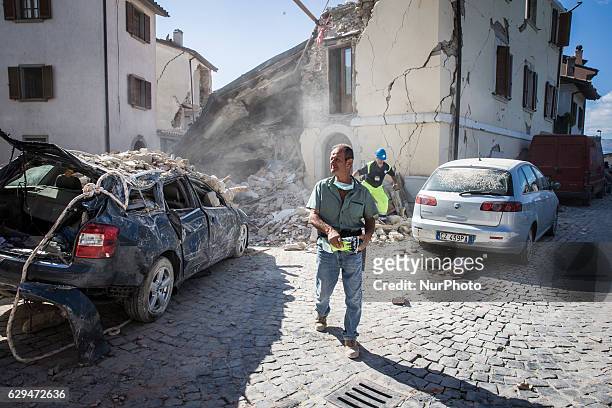 Rescuers search for victims in damaged buildings after a strong earthquake hit Amatrice on August 24, 2016. Central Italy was struck by a powerful,...