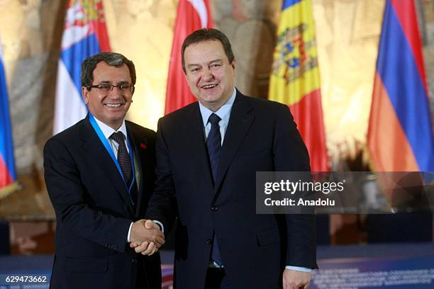 Serbian Foreign Minister Ivica Dacic and Turkey's Deputy Foreign Minister Ahmet Yildiz shake hands during the 35th Organization of the Black Sea...